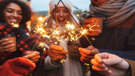 A group of friends waving sparklers.