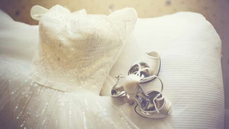 A wedding dress and shoes displayed.