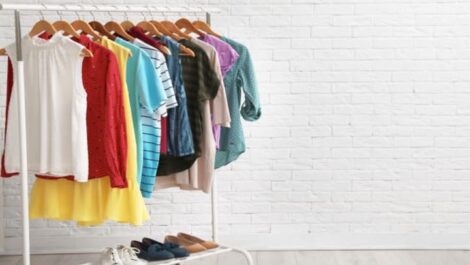 Women's clothes hanging on a clothing rack.