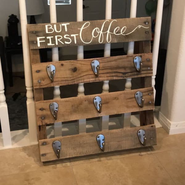 A coffee mug holder made out of a wood pallet. 