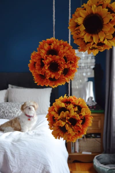 DIY sunflower orbs hanging in a bedroom. 