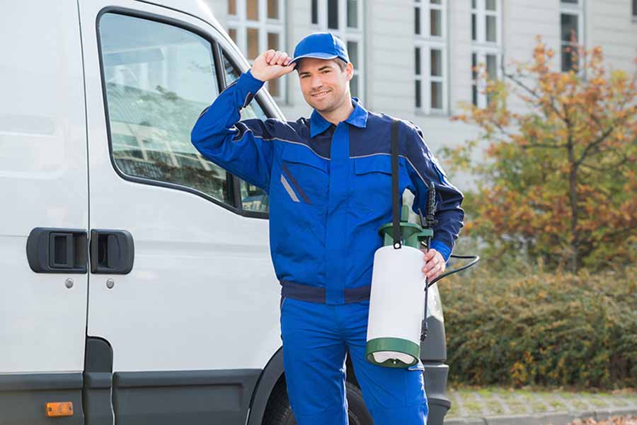 Man standing outside work truck.