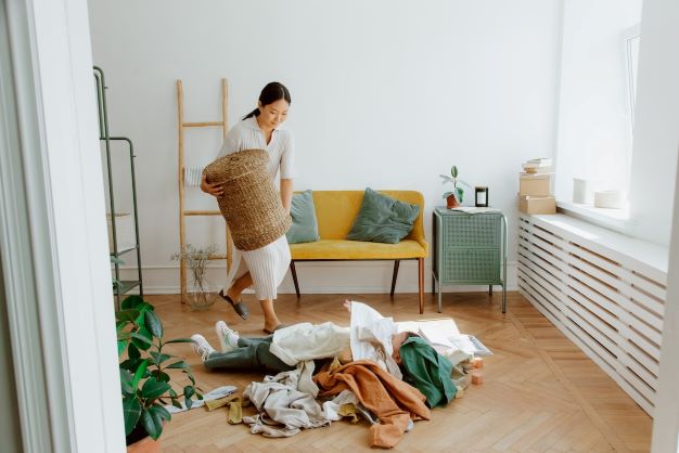 Woman emptying her laundry basket.