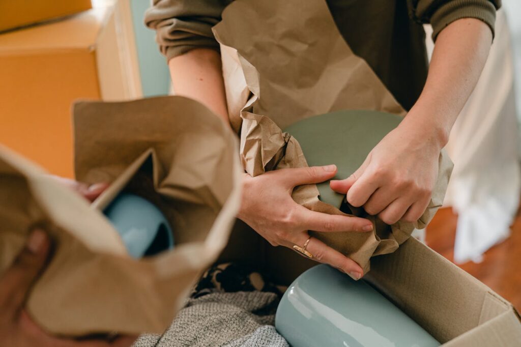 Two people wrapping items in eco-friendly packing materials